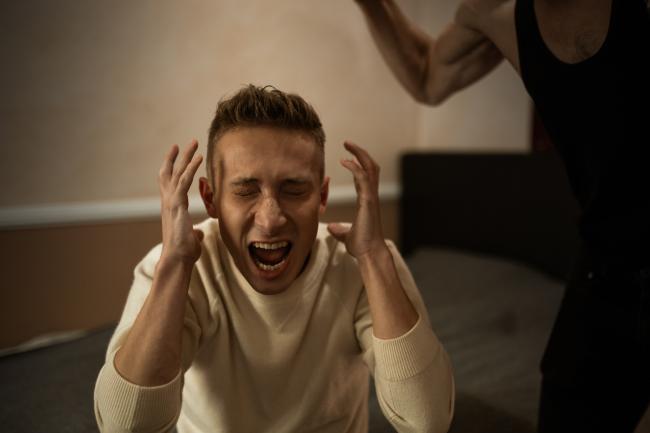 An emotionally abused Man in White Long Sleeve Shirt Screaming