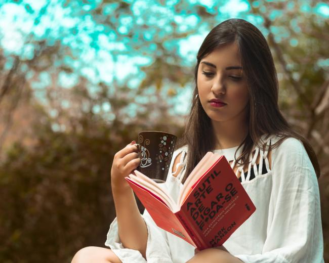 Photo of Girl In White Dress Reading A Book